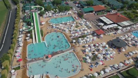 Aerial-View-of-People-at-Swimming-Pool-in-Camping-Lido-Lazise,-Lake-Garda,-Italy