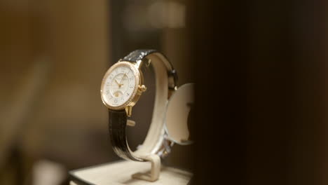 Golden-luxury-wristwatch-with-transparent-back-for-sale,-reveal-shot