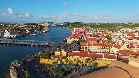 Golden-hour-light-spread-across-Willemstad-vibrant-colored-buildings-with-ship-docked-in-port