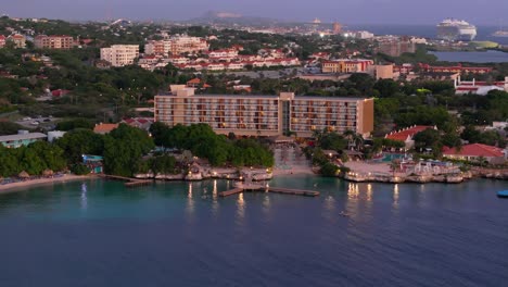 Drone-orbit-and-push-in-to-hotel-with-wooden-docks-looking-out-over-beautiful-Caribbean-water