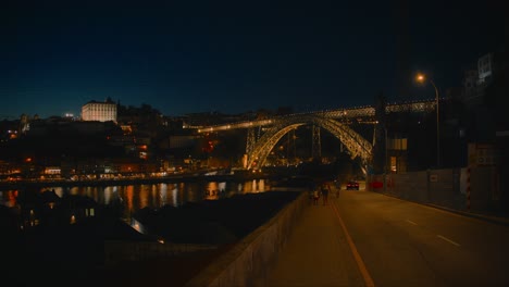 People-Walking-Towards-Landmark-Dom-Luis-I-Bridge,-Touristic-Spot-in-Porto