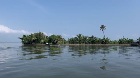 pov-shot-A-lot-of-coconut-trees-and-buildings-are-visible-in-the-water-around-and-there-are-waves-in-the-water
