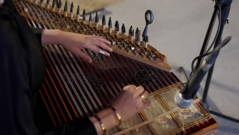 -woman-playing-on-Zither-in-the-theatre-high-angle-shot,-close-up