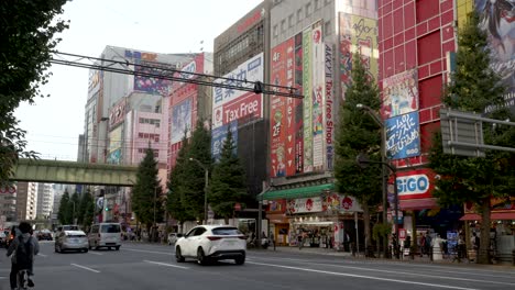Traffic-Going-Past-Along-Main-Street-Road-In-Akihabara