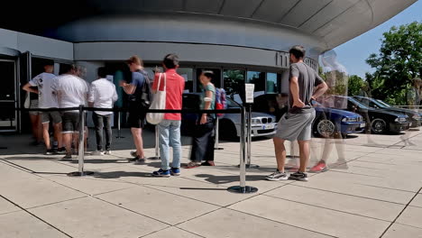 Time-lapse-of-visitors-queuing-at-the-BMW-Museum-for-the-50th-anniversary-of-the-BMW-M-series,-featuring-an-M5-E39