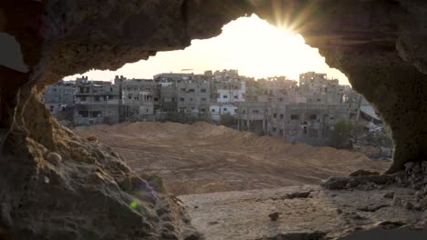 Looking-out-through-remains-of-a-wall-towards-destroyed-city-blocks-in-Gaza