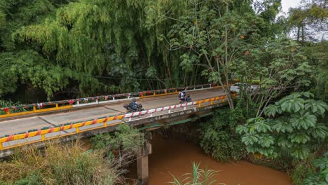 Aerial-Timelapse-Small-Bridge-with-Cars-and-Dark-Water-River-Jamundi,-Colombia
