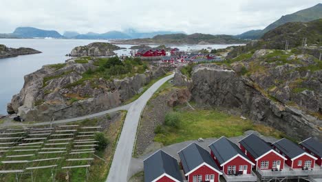 Lofoten-Islands-Red-Cabins-'Rorbuer'-in-Mortsund-Fishing-Village,-Norway---Aerial-4k