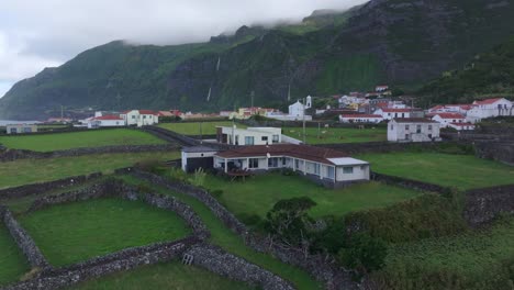 Wide-view-of-luxury-villa-at-Fajã-Grande-town-in-Flores-Azores,-aerial