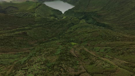 Reveal-shot-of-famous-crater-lakes-Rasa-and-Funda-in-Flores-azores,-aerial