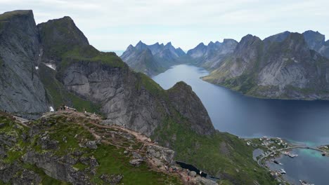 Reinebringen-Hike-in-Lofoten-Islands,-Norway---Aerial-View-of-People-enjoy-View-on-Top-of-the-Mountain