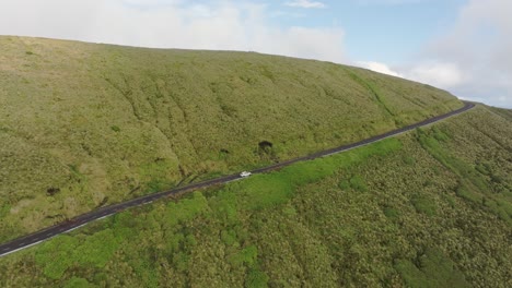Aerial-view-of-car-driving-on-mountain-road-at-Flores-Azores