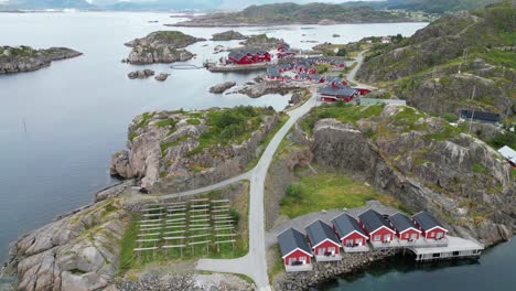 Lofoten-Islands-Red-Cabins-'Rorbuer'-in-Mortsund-Fishing-Village,-Norway---Aerial-4k-Tilting-Up