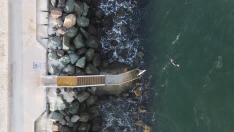 Surfers-using-a-newly-constructed-ocean-platform-and-stairs-providing-safe-access-to-a-popular-surf-beach