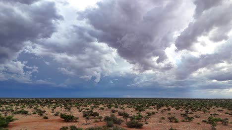 Amazing-aerial-drone-shot-moving-towards-an-approaching-storm-with-lightning-strikes-in-the-cloudy-blue-sky-in-Southern-Kalahari