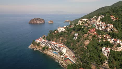 Mexican-Fishermen's-Village-Houses-Above-Hill-Next-to-Ocean,-Mismaloya-Aerial-Drone-Landscape