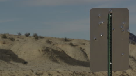 Sign-in-the-desert-with-bullet-holes