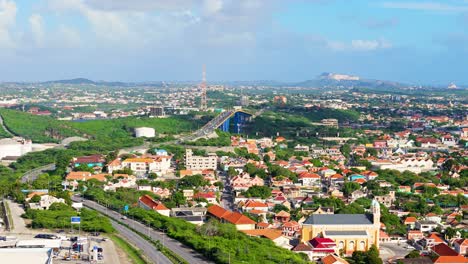 Drone-left-to-right-pan-establishes-urban-suburb-of-Willemstad-below-Queen-Juliana-Bridge-Curacao