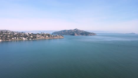 Aerial-video-capturing-Angel-Island's-natural-beauty,-Sausalito's-coastal-charm,-and-the-distant-urban-silhouette-of-San-Francisco