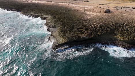 Jagged-layers-of-eroded-basalt-shelves-and-pools-bombarded-by-crystal-clear-ocean-water