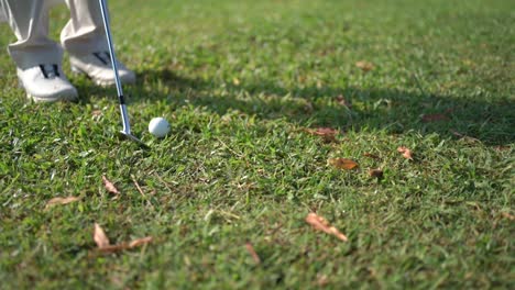 closeup-to-the-ball,-golfer-hits-the-ball-with-stick