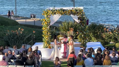 Lesbian-couple-during-Indian,-Caucasian-Wedding-Ceremony-In-San-Diego,-Coronado-Bay