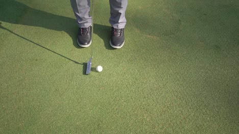 closeup-to-the-ball,-golfer-hits-the-ball-with-stick