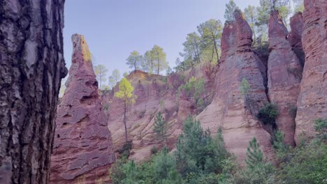 Exciting-rock-pillar-in-nature-with-colored-rocks-in-the-background-and-some-trees