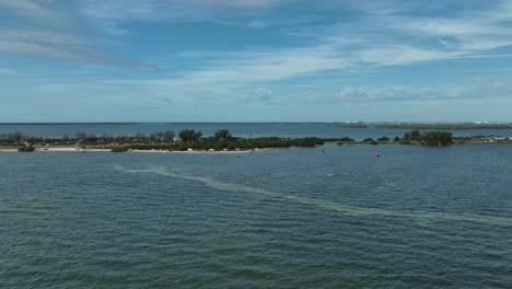 Drone-approaching-kitesurfing-near-a-highway-peninsula-near-St-Petersburg-in-Florida