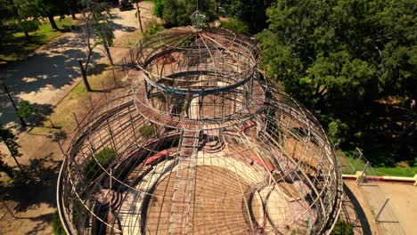 Aerial-orbit-over-the-abandoned-Art-Nouveau-greenhouse-of-the-Quinta-Normal-in-Santiago-Chile-on-a-sunny-day,-without-glasses
