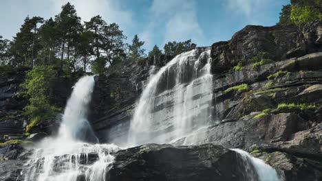 Tvindefossen-waterfall-cascades-from-the-dark-rocky-cliffs