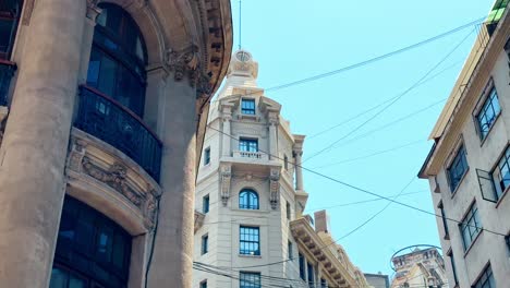 Tilt-Up-Picturesque-Historic-Center-Ariztia-Building-Shot-in-La-Bolsa-Santiago-de-Chile-Business-Neighborhood,-Nueva-York-Street