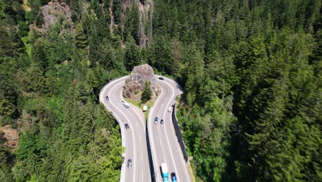 Aerial-view-of-traffic-on-an-impressive-curve-in-the-mountains