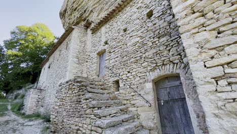 old-house-made-of-rough-stones-with-stairs-and-old-door-in-france-historic-old-farm