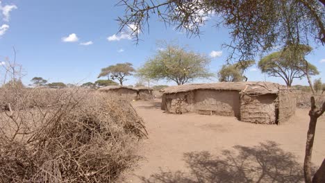Traditional-mud-huts-in-Maasai-tribe-village,-African-culture-and-heritage-reserve
