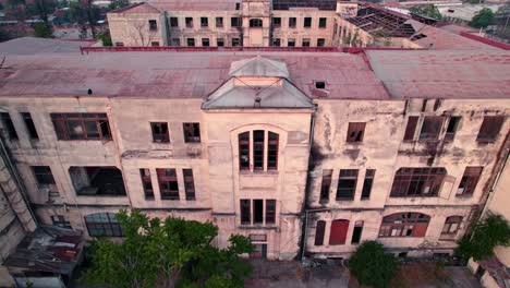 Drone-Panoramic-Establishing-Shot-of-Abandoned-Hospital-Building-Medical-Complex-Square-at-Ex-Maternity-Room