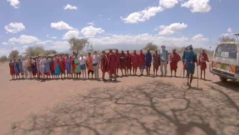 European-tourists-enjoy-traditional-Maasai-African-tribal-dance-and-jumps-performance