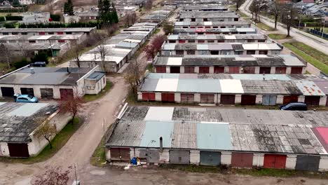 Establishing,-Aerial-view-of-privately-owned-old-fashioned-car-garages-from-soviet-Era-in-Lithuania,-Silute