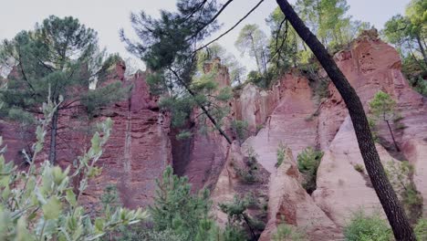 Exciting-rock-structure-in-nature:-steep-colored-ocher-rock-face-with-individual-columns