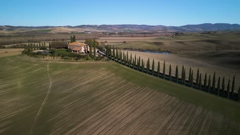 Angled-aerial-trucking-pan-orbit-around-mansion-overlooking-Tuscan-countryside