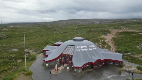 Tourist-People-Visit-Arctic-Circle-Centre-in-Storforshei,-Norway---Aerial