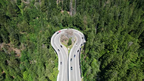 Aerial-view-of-traffic-on-an-impressive-curve-in-the-mountains
