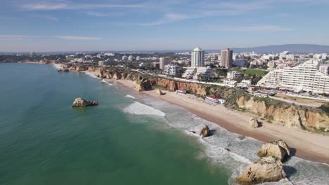 Establishing-aerial-of-beautiful-long-beach-of-praia-dos-Tres-Castelos-in-Portimao