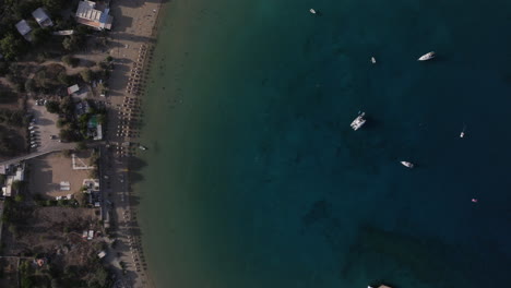 Top-down-aerial-shot-from-a-beach-to-a-beautiful-blue-bay