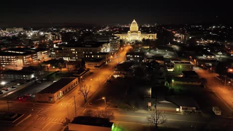 Arkansas-State-Capitol-building-at-night-in-Little-Rock,-Arkansas-with-drone-video-moving-up-at-an-angle