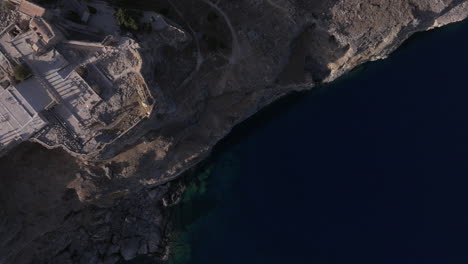 Top-down-aerial-shot-from-the-sea-to-the-Acropolis-to-lindos-town-Rhodes