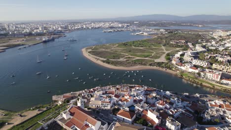 Ferragudo-town-in-Portugal,-establishing-aerial-view-of-townscape-and-marina
