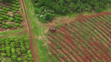 Drone-aerial-pan-of-tractor-equipment-machinery-farming-cultivation-crops-plantation-agriculture-industry-on-farm-Santa-María-Misiones-Argentina-South-America-4K