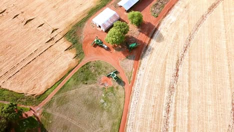 Drone-birds-eye-view-of-agricultural-machines-waiting-to-go-harvest-wheat