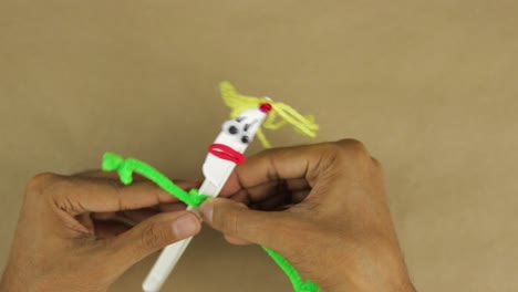 Creating-playful-figurine-from-disposable-plastic-knife-and-scraps